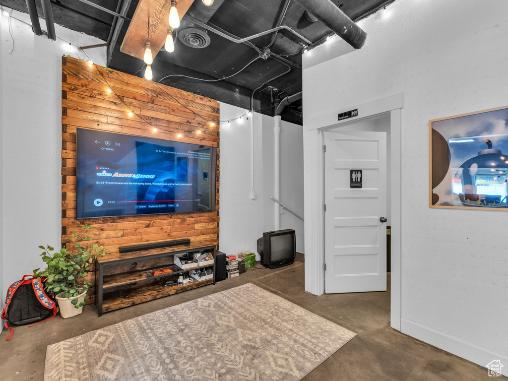 Living room with unfinished concrete floors and baseboards