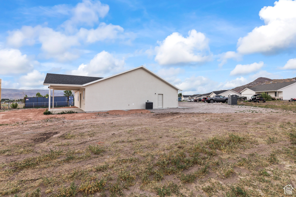 View of home's exterior with stucco siding and cooling unit
