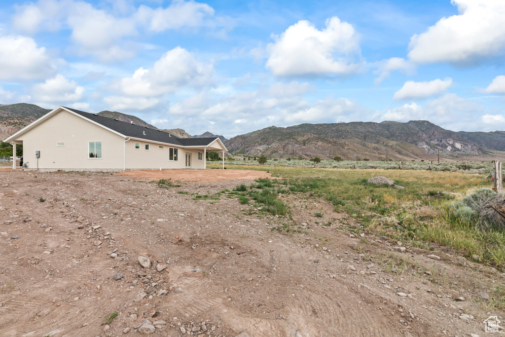 View of home's exterior with a mountain view and stucco siding