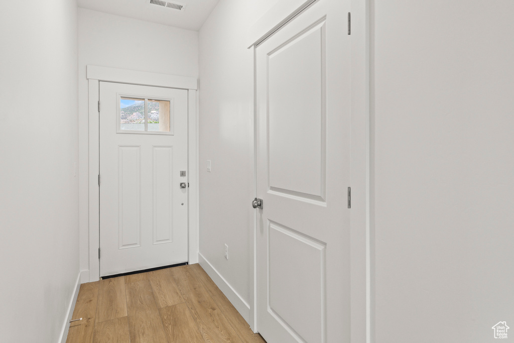 Entryway featuring light wood-style floors and baseboards