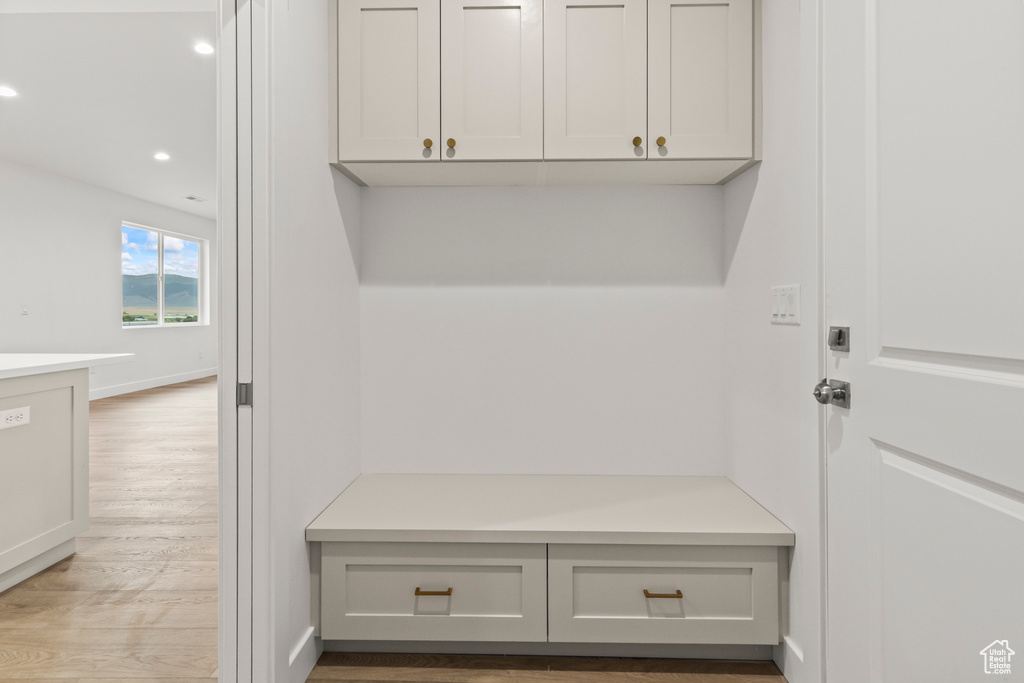 Mudroom with wood finished floors, recessed lighting, and baseboards