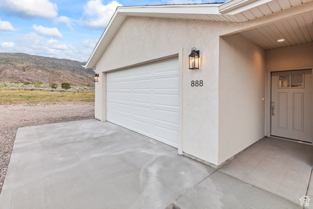 Garage with a mountain view and concrete driveway