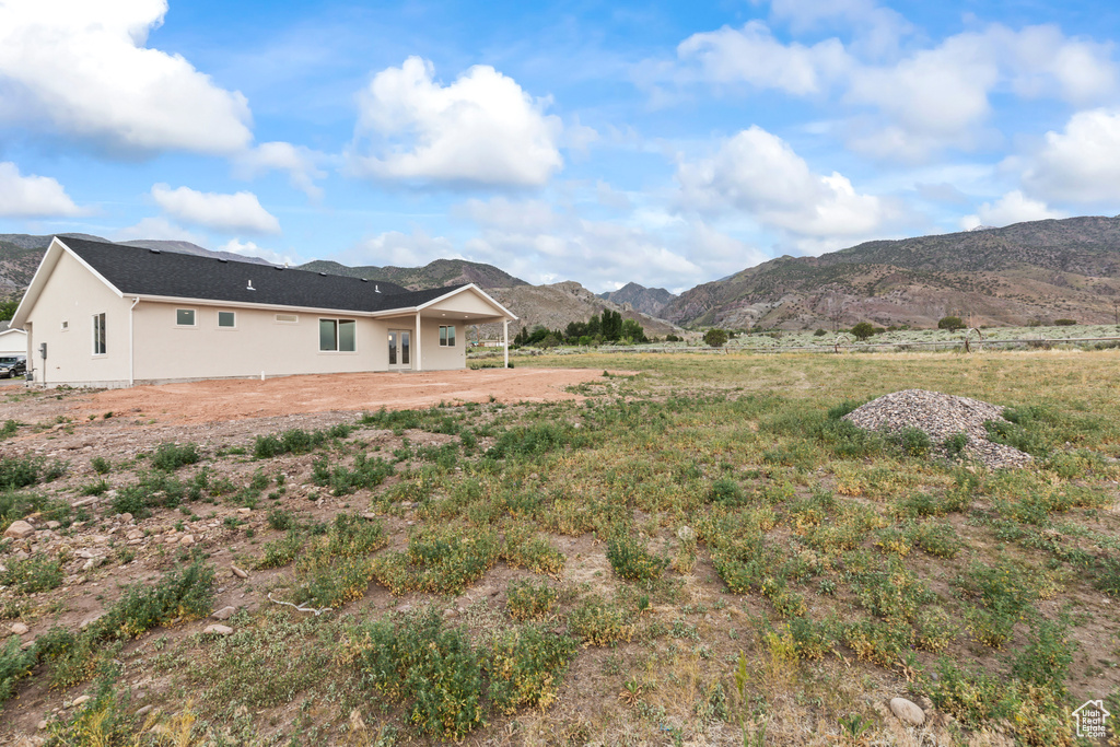 Back of property with a mountain view
