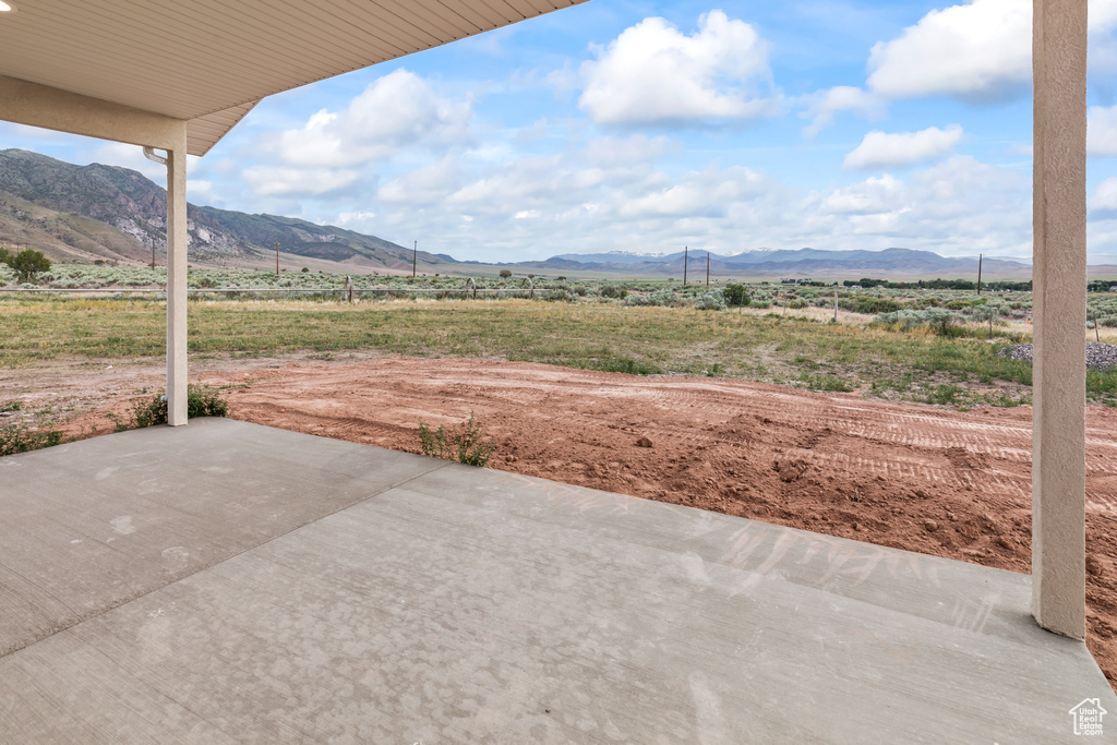 View of patio featuring a mountain view and a rural view