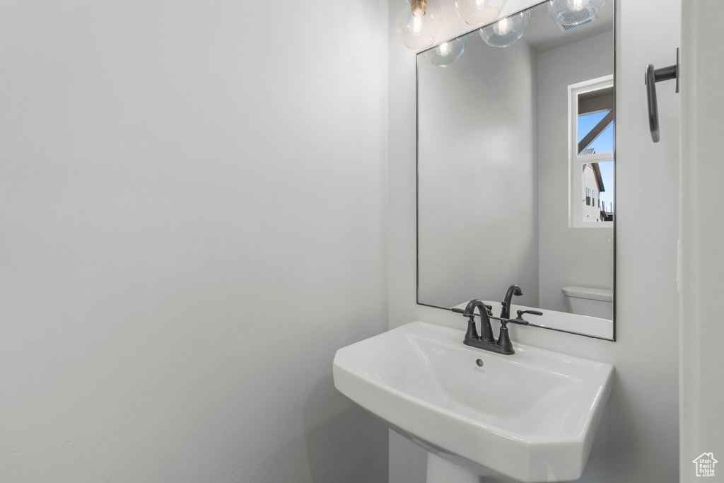 Half bath with a sink and toilet