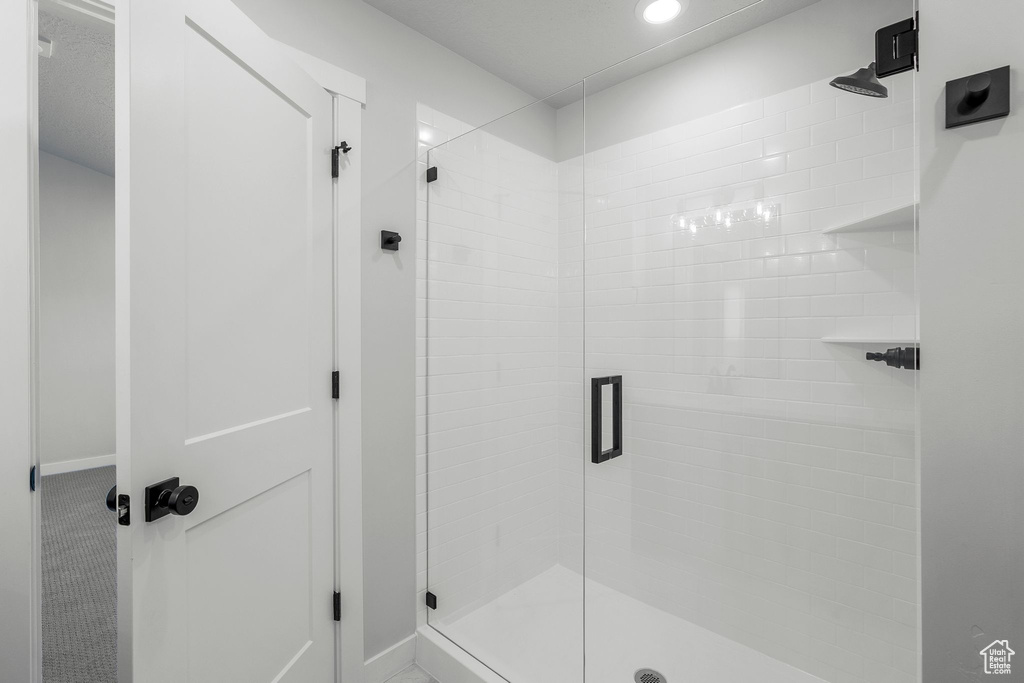 Bathroom with a stall shower, recessed lighting, and baseboards