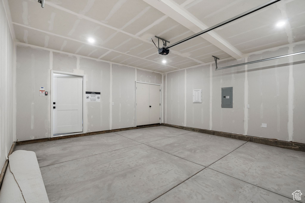 Garage with electric panel and a garage door opener