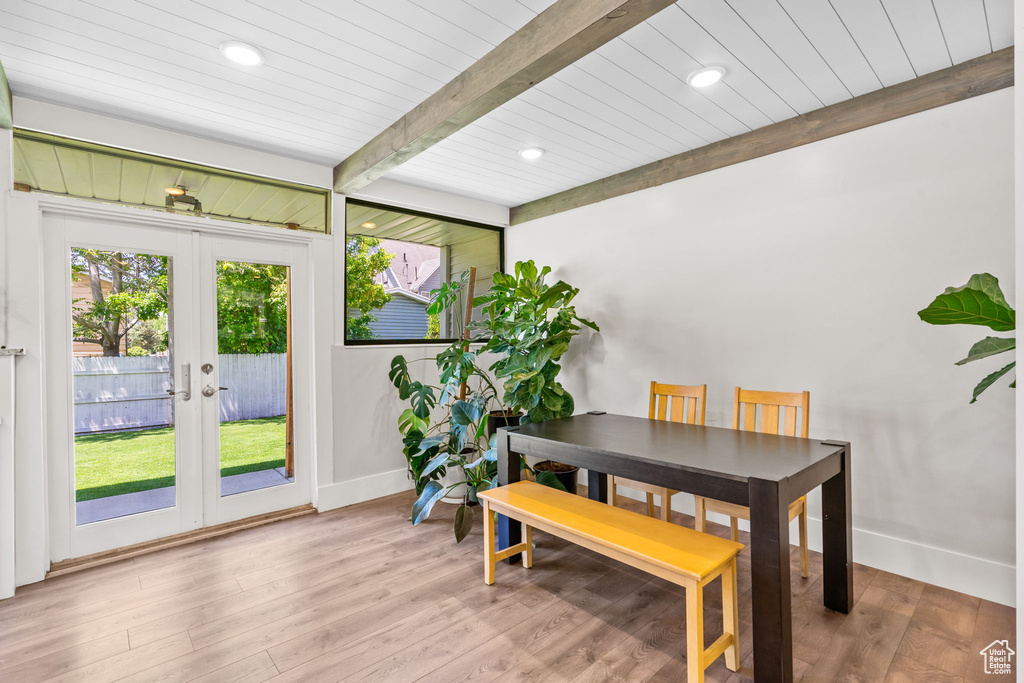 Dining area with baseboards, french doors, wood finished floors, wooden ceiling with exposed beams, and recessed lighting