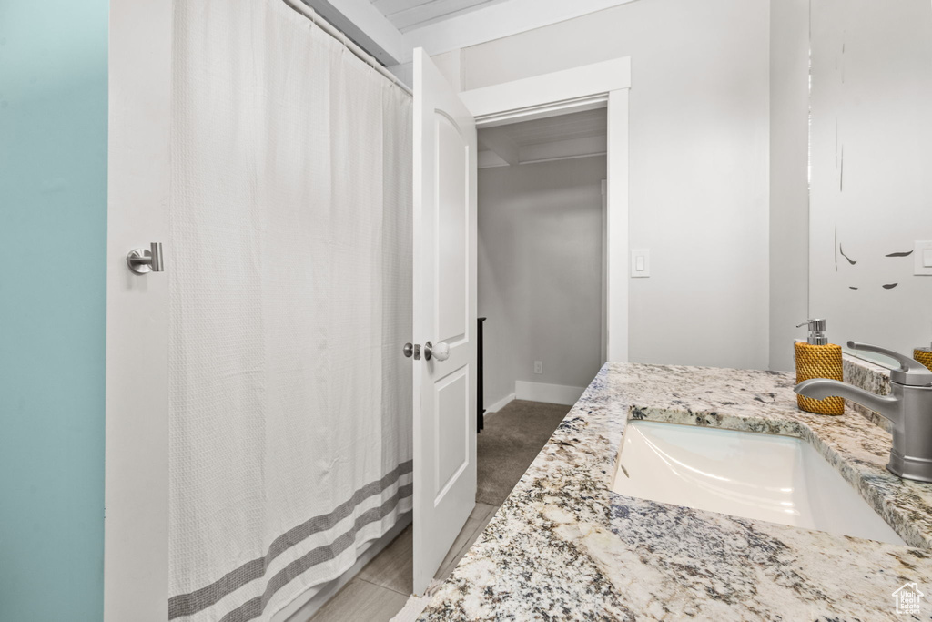 Bathroom featuring vanity and curtained shower