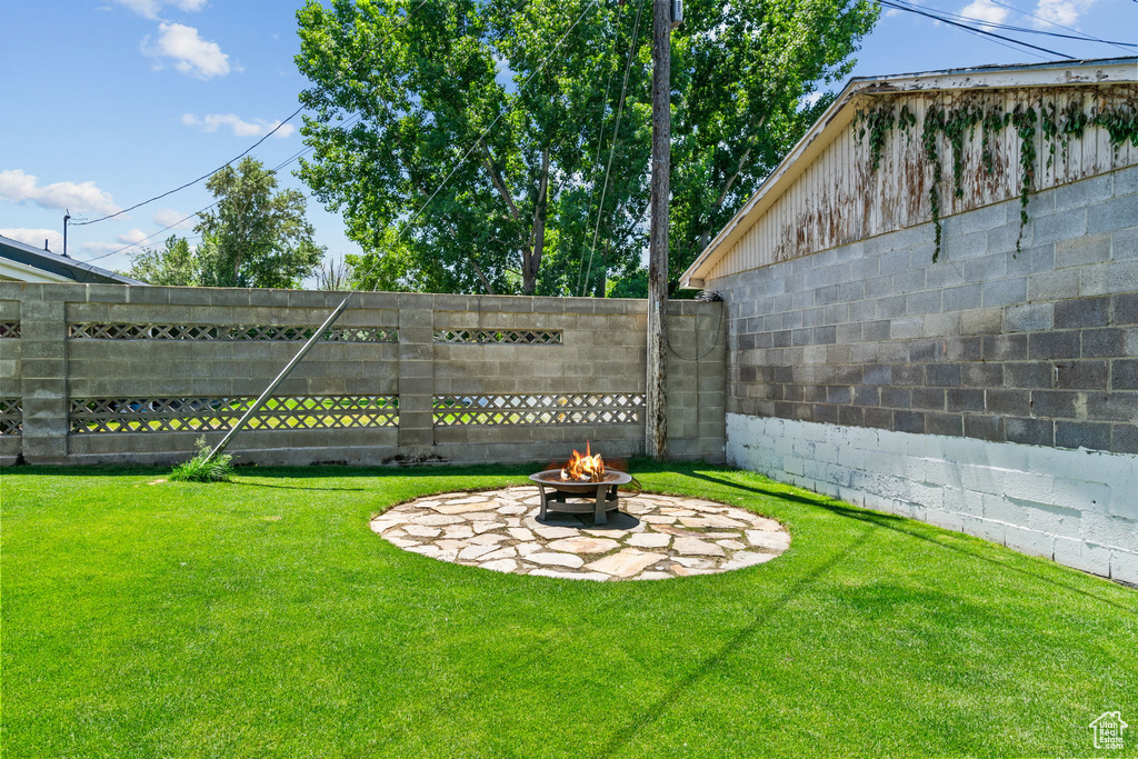 View of yard with a fire pit and a patio area