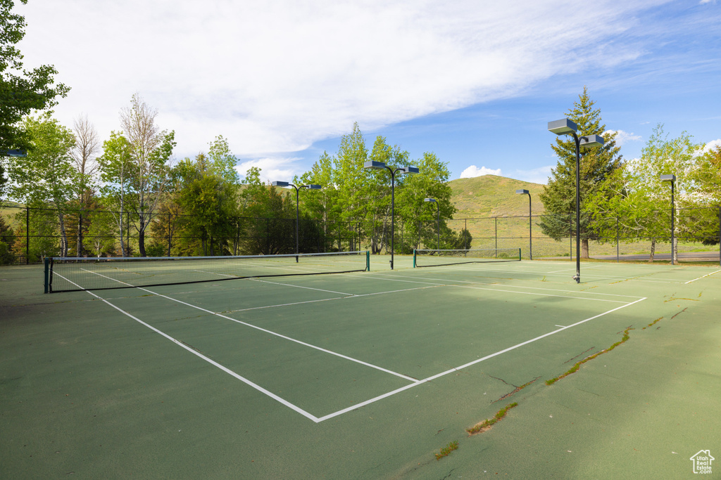 View of tennis court featuring a mountain view and community basketball court