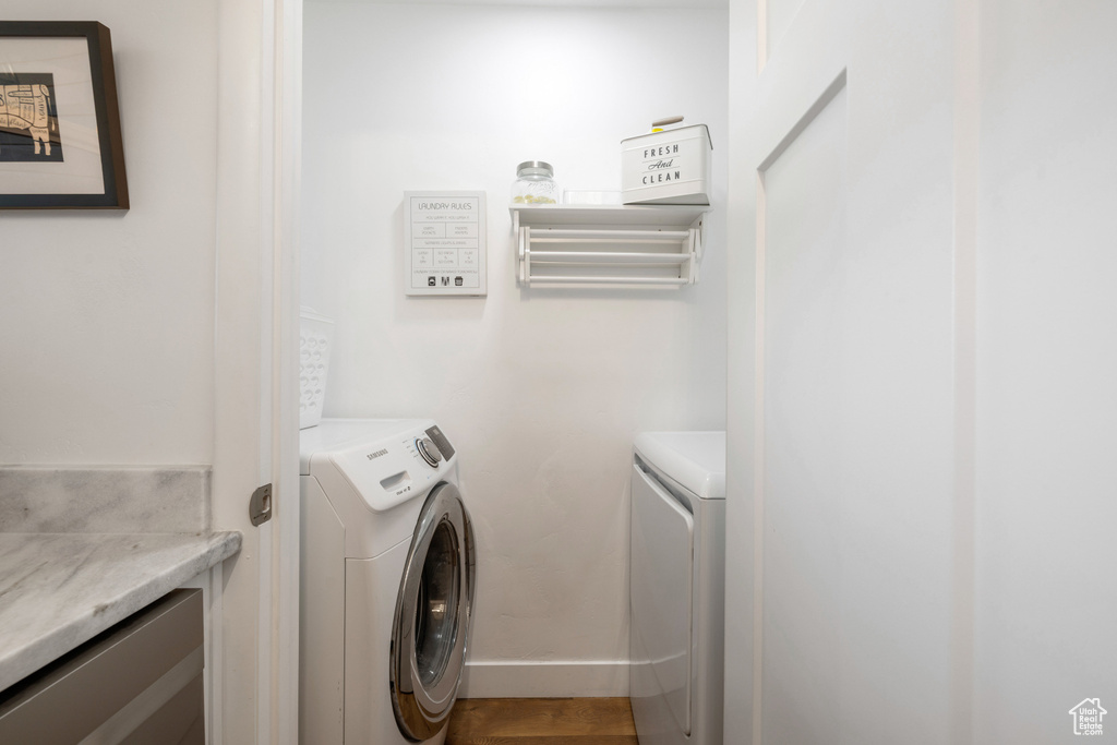 Laundry area featuring washer and clothes dryer and baseboards