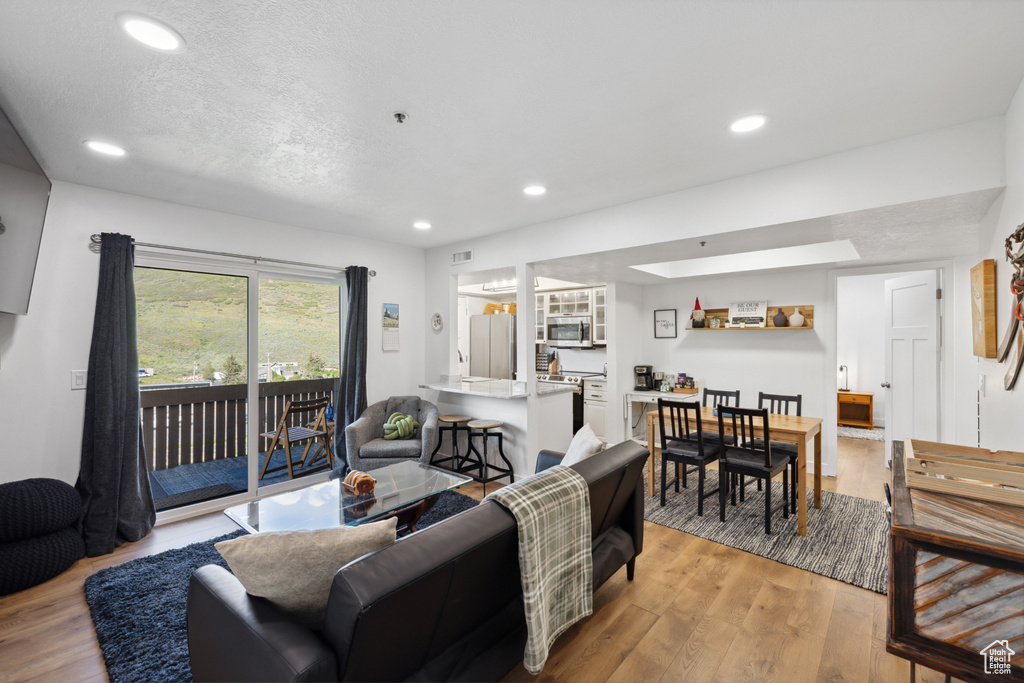 Living room featuring recessed lighting and light wood-style floors