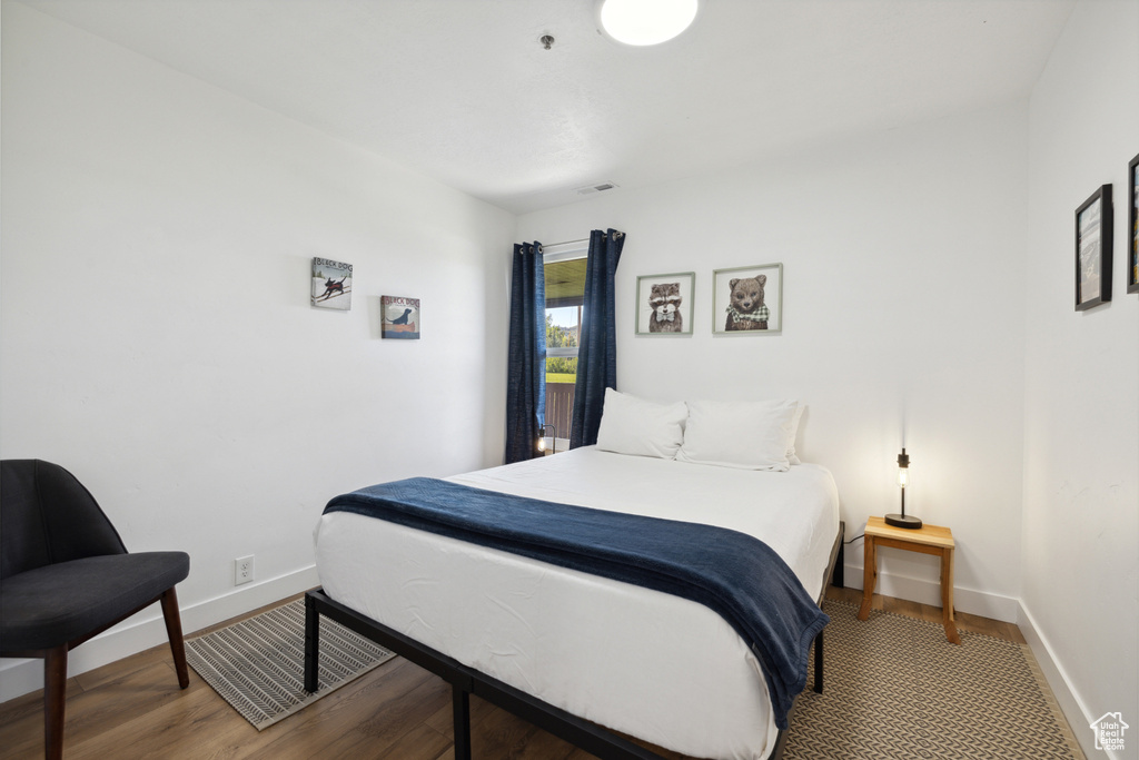 Bedroom featuring baseboards and wood finished floors
