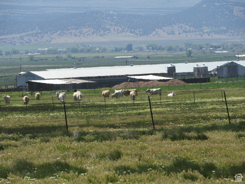 Mountain view with rural landscape, a pastoral area, and a large body of water