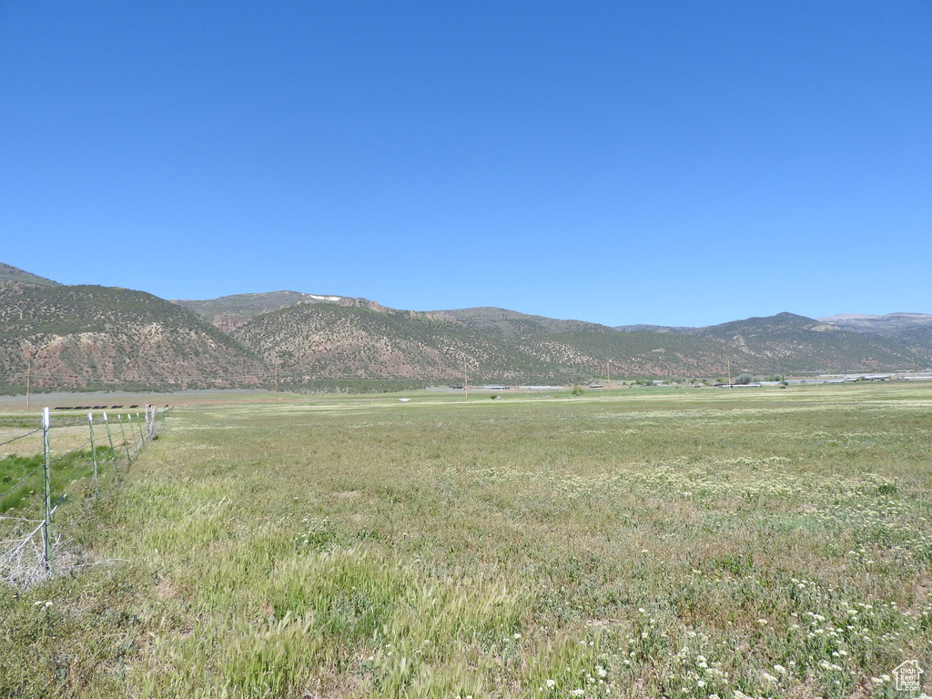 View of mountain backdrop with rural landscape