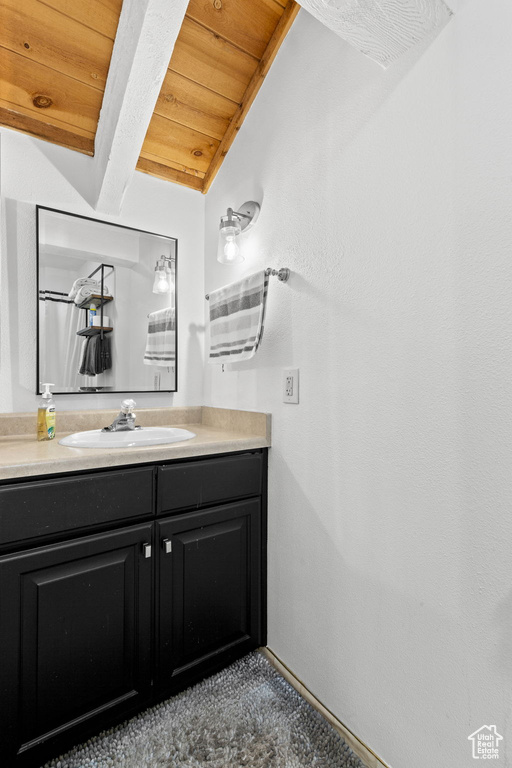 Bathroom featuring wooden ceiling and vanity