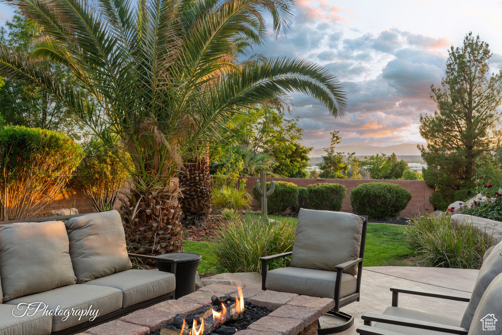 Patio terrace at dusk with an outdoor fire pit and a patio area