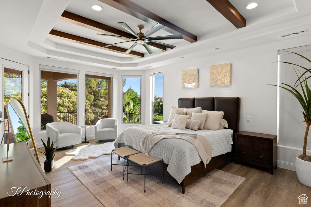 Bedroom featuring wood finished floors, beam ceiling, recessed lighting, baseboards, and a ceiling fan