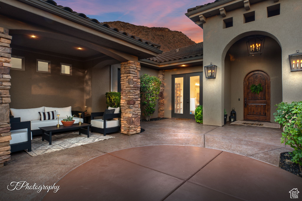 Patio terrace at dusk with french doors, a patio, and outdoor lounge area
