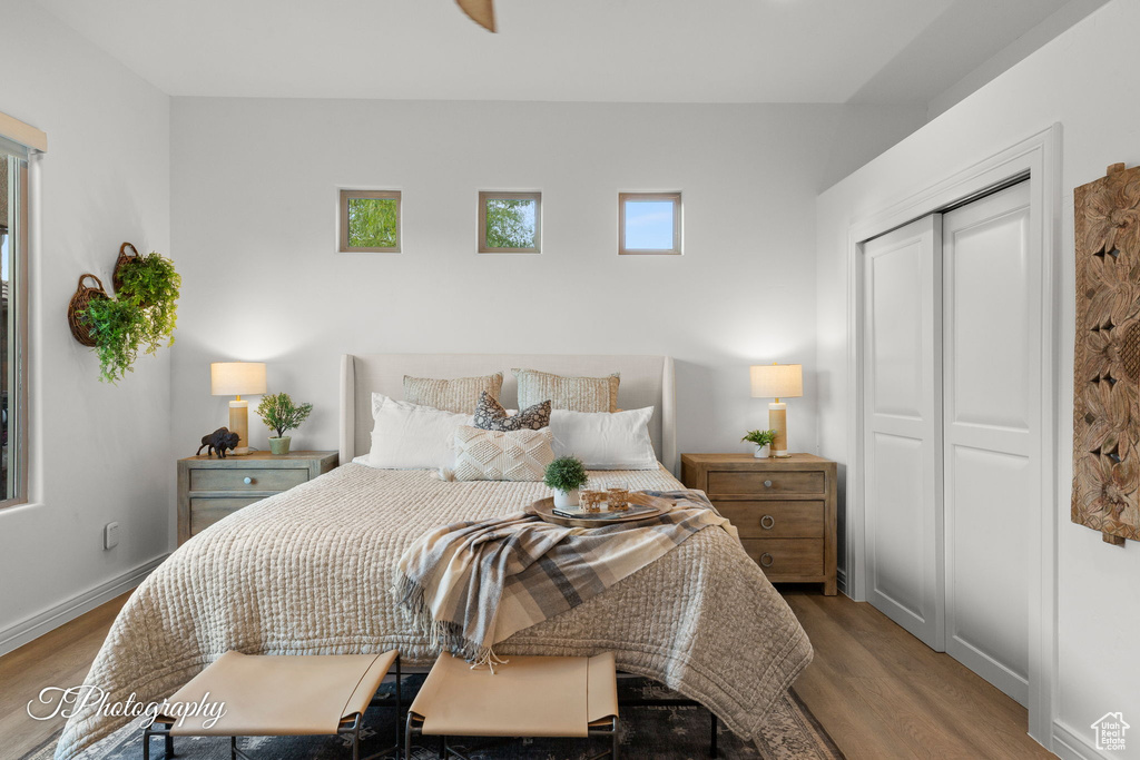 Bedroom featuring wood finished floors, baseboards, and a closet