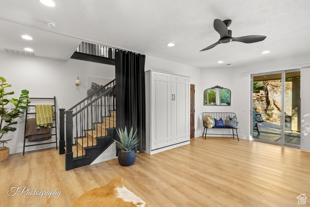 Foyer featuring stairs, wood finished floors, recessed lighting, ceiling fan, and baseboards