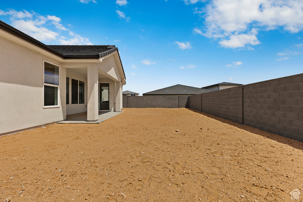 Fenced backyard featuring a patio