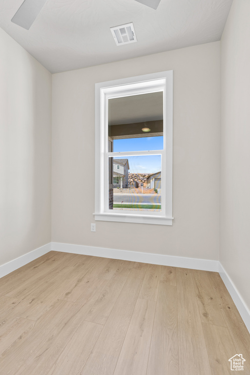 Unfurnished room featuring wood finished floors and baseboards