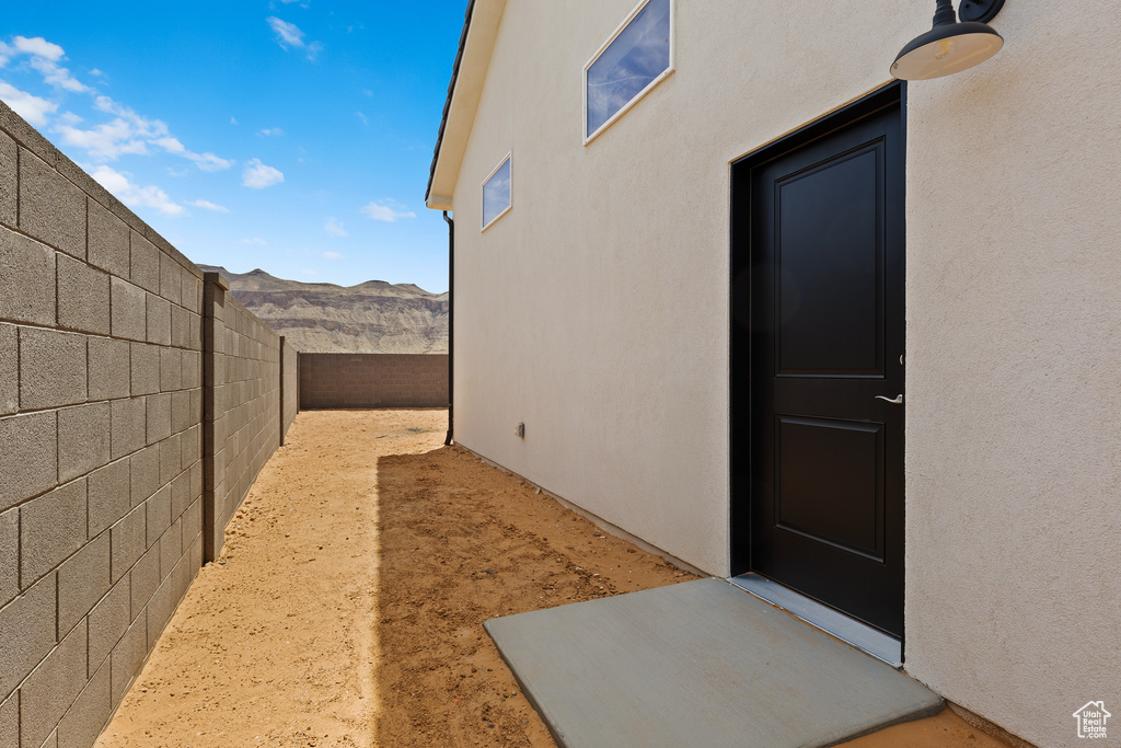 Property entrance with stucco siding and a mountain view