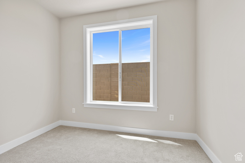 Unfurnished room featuring carpet flooring and baseboards