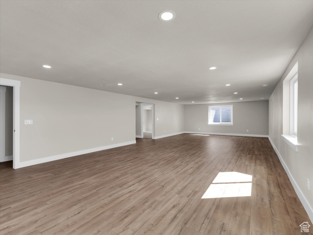 Empty room with recessed lighting, wood finished floors, and baseboards