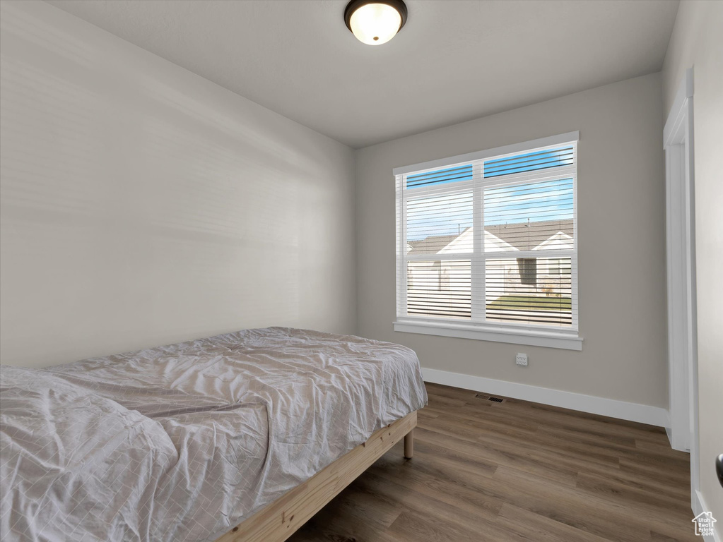 Bedroom with baseboards and wood finished floors