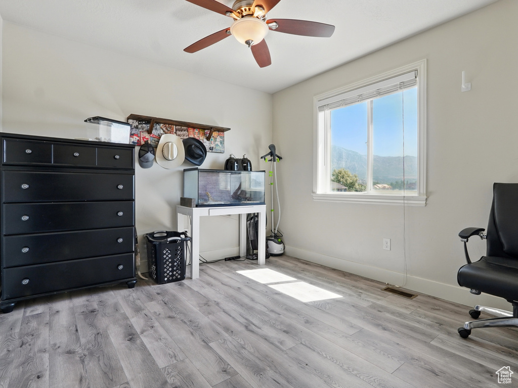 Office area featuring wood finished floors, baseboards, and a ceiling fan