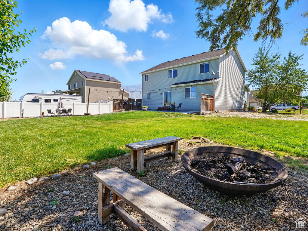 Back of house featuring a fire pit