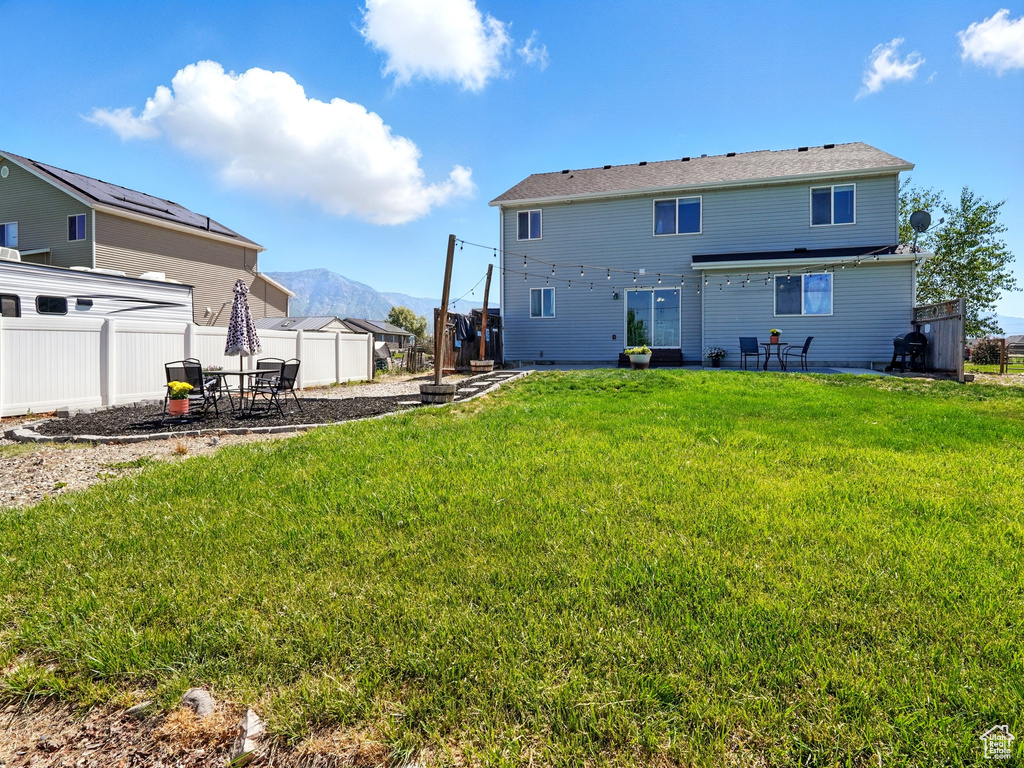Back of property with a patio area and a mountain view