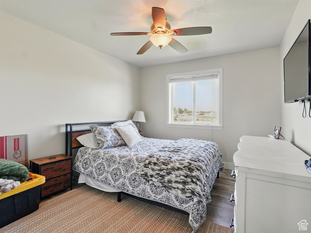 Bedroom with wood finished floors and ceiling fan