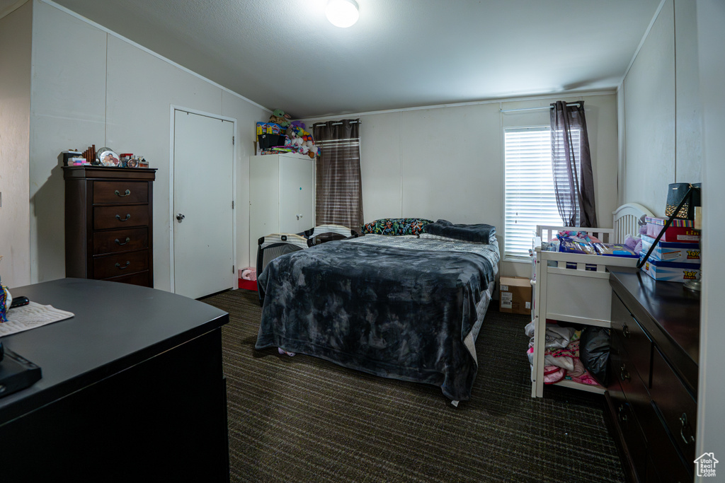 Bedroom featuring vaulted ceiling and carpet floors