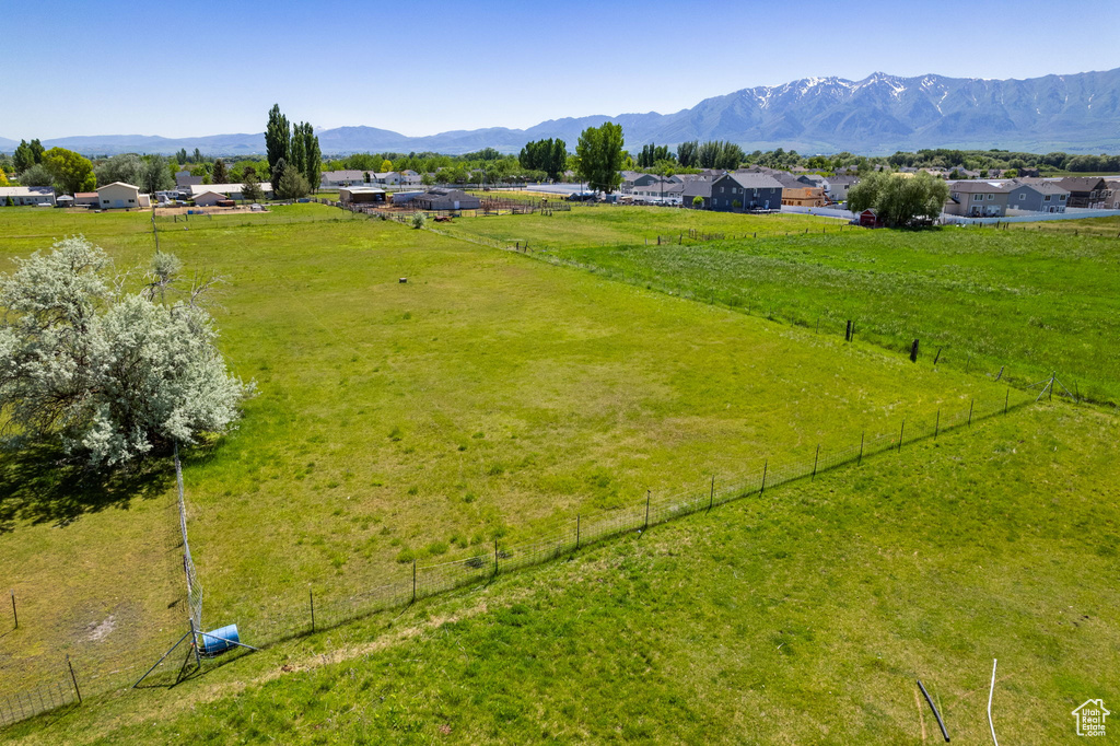 Overview of rural landscape with a pastoral area and a mountain backdrop