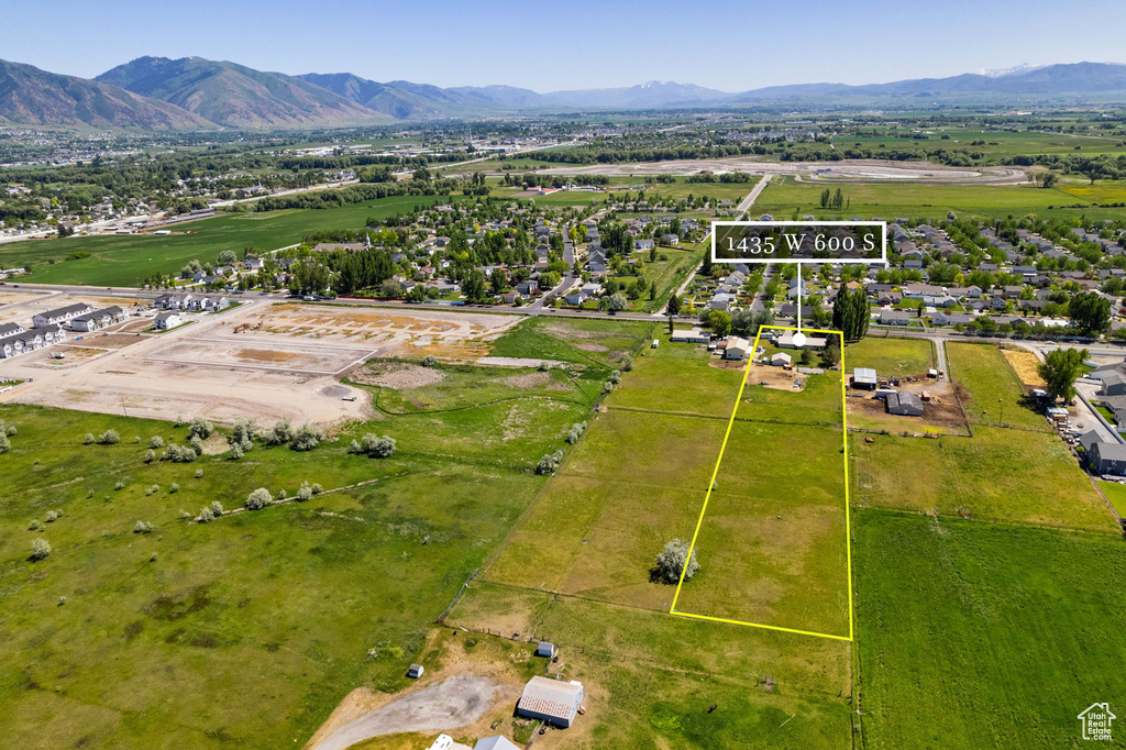Aerial overview of property's location featuring a mountain backdrop and property boundaries highlighted