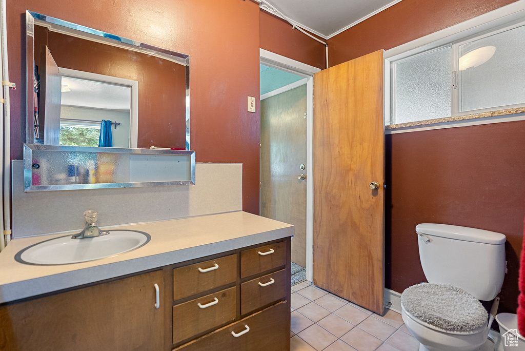 Bathroom featuring vanity, toilet, and tile patterned floors