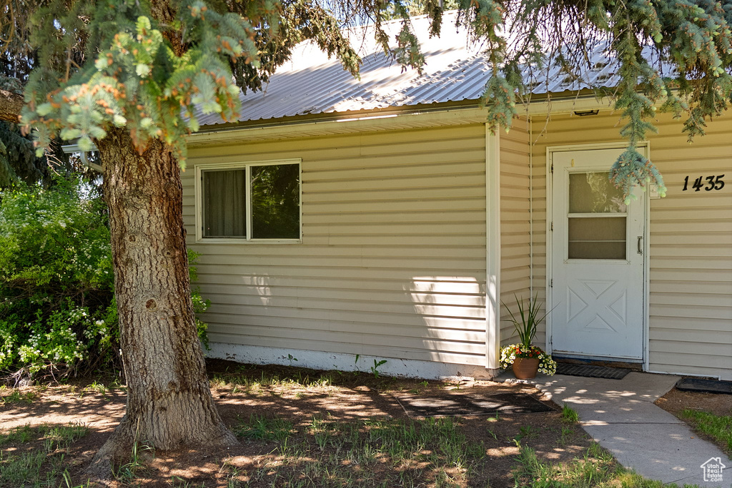 View of exterior entry featuring metal roof