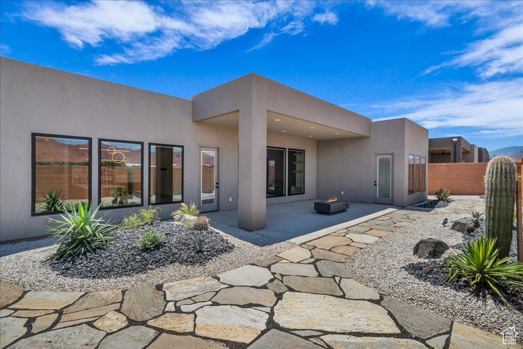 Back of property featuring stucco siding and a patio