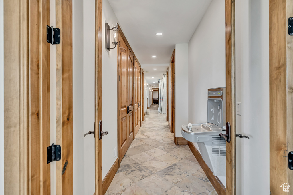 Hall with recessed lighting and baseboards