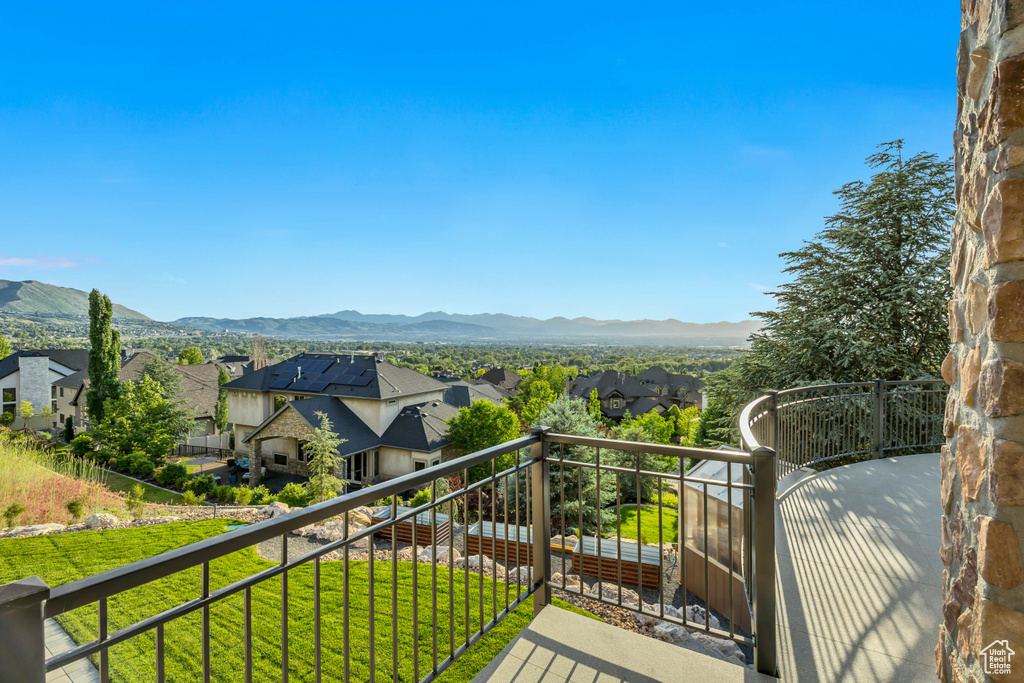Balcony featuring a residential view and a mountain view