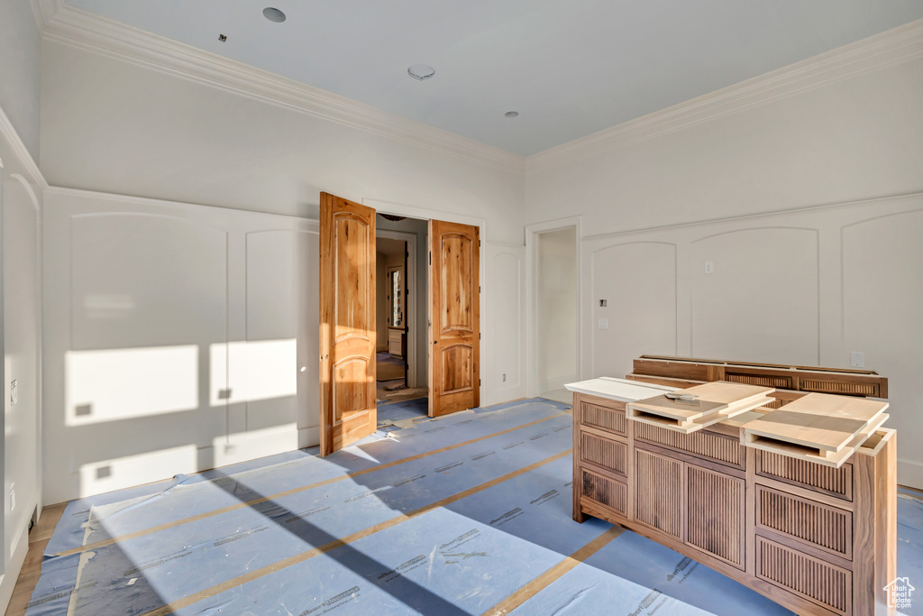 Bedroom featuring crown molding and a decorative wall