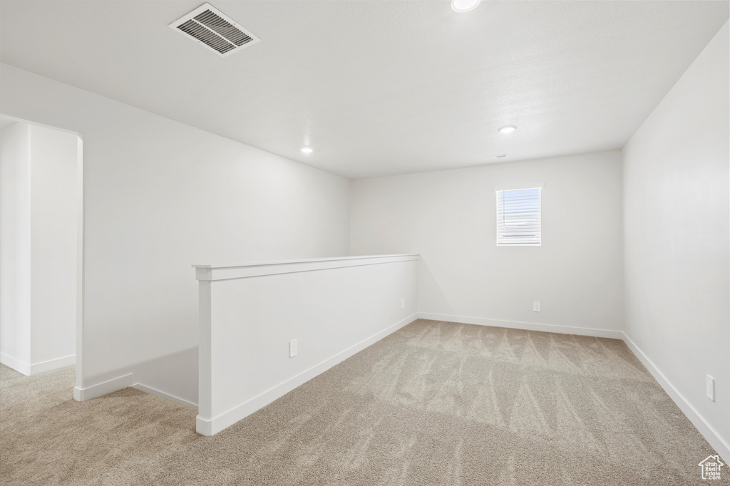 Empty room featuring carpet flooring and recessed lighting