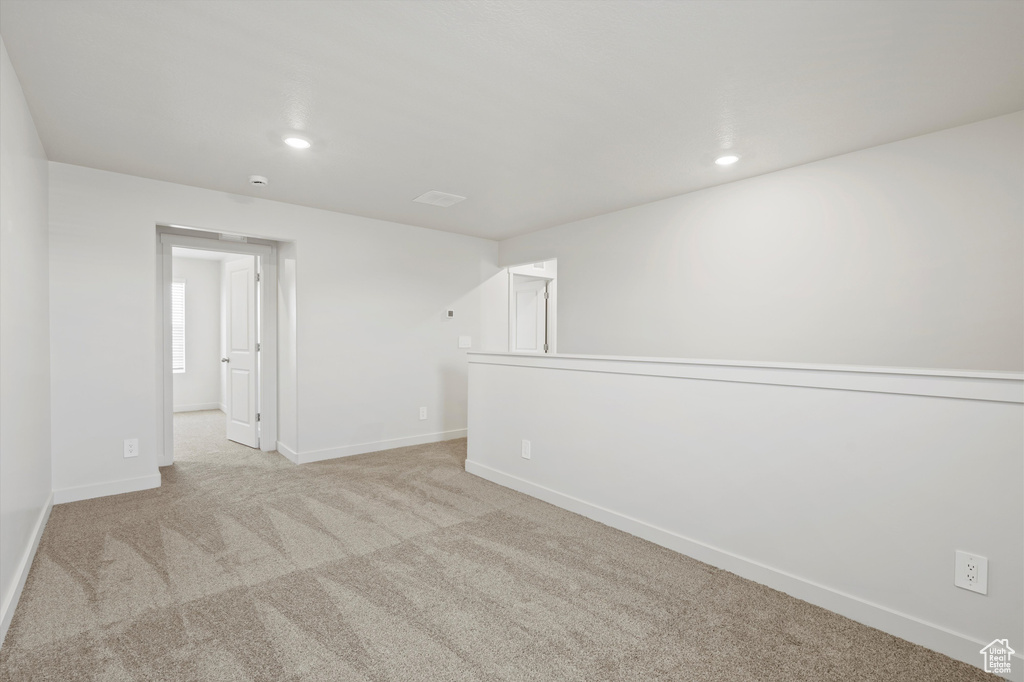 Empty room with carpet and recessed lighting