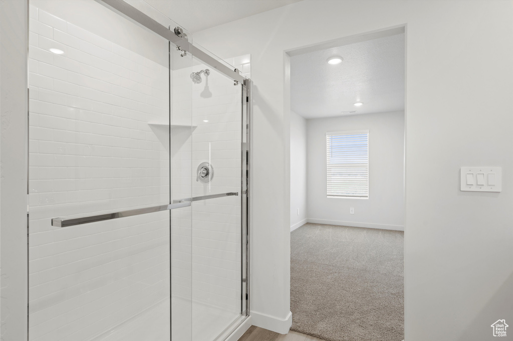 Full bath featuring a shower stall and recessed lighting