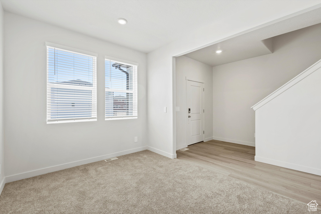 Carpeted entrance foyer featuring recessed lighting and wood finished floors