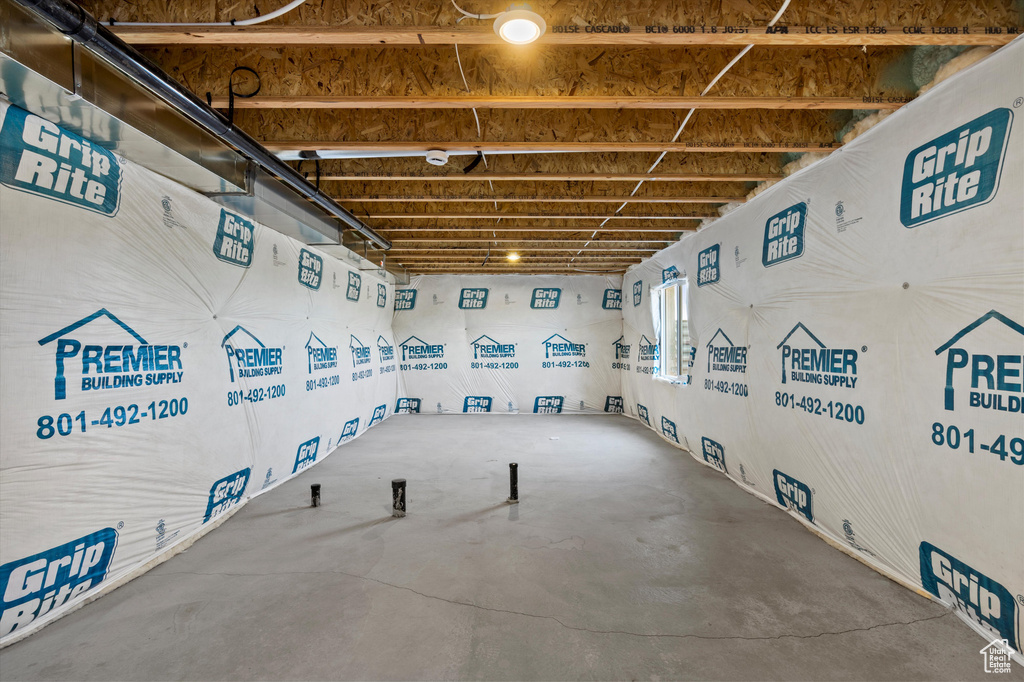 Misc room featuring unfinished concrete flooring